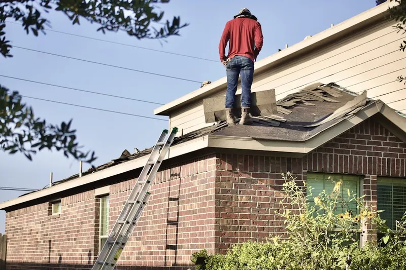 Professional roofer working on a residential roof in North Babylon
